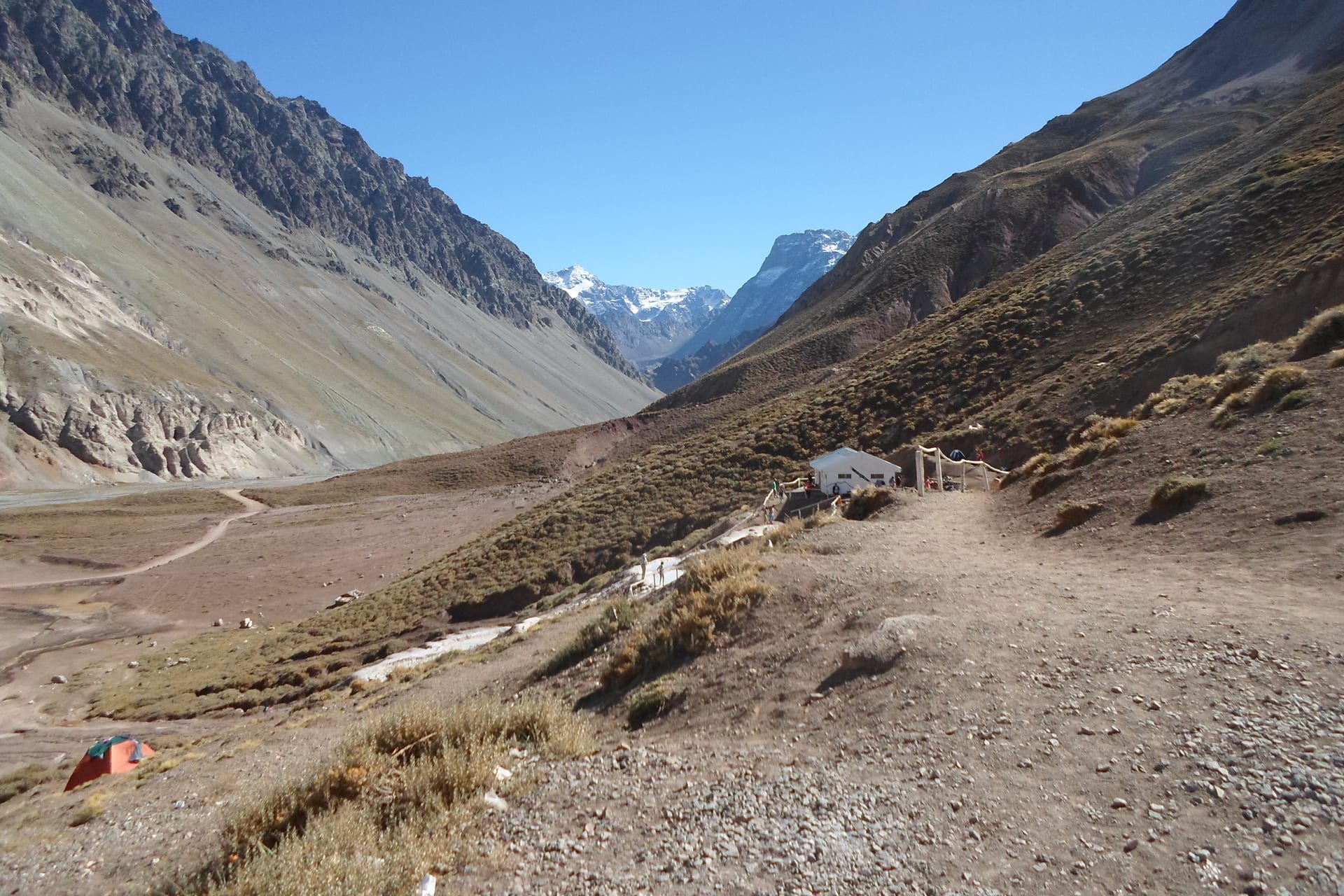 Terraced hot spring pools at Baños Colina, San José de Maipo, surrounded by mountains.